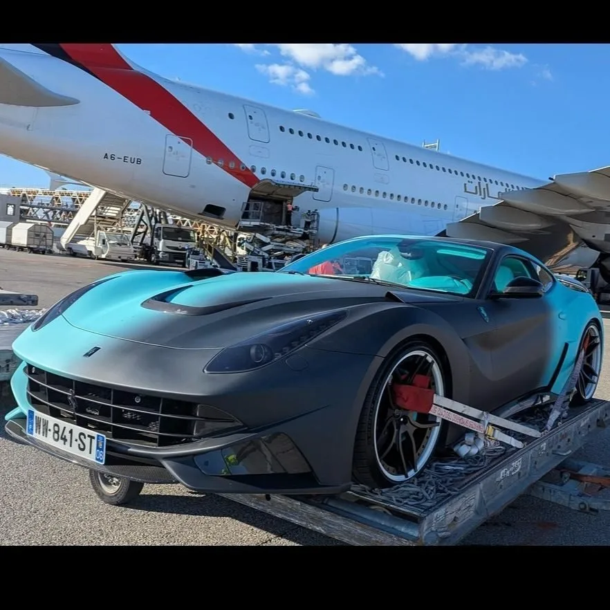 Ferrari F12 on cargo pallet, Emirates A380 tail